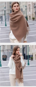Detail of soft brown cashmere-like scarf showing thick texture and tassel fringe edges