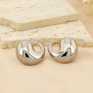 Macro view of high-polished silver bean shaped earrings with smooth metallic finish
