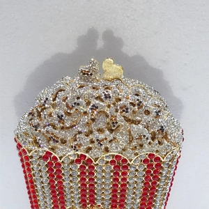 Detailed view of popcorn-shaped evening bag with red-white stripes and crystal accents