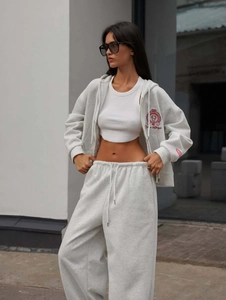 Women's grey two-piece street style tracksuit with zip-up hoodie and high waist jogger pants