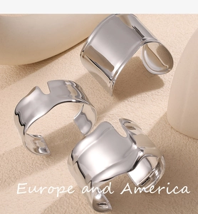 Detailed macro view of silver irregular wide open bangles with geometric hollow design