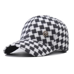 Classic black and white houndstooth baseball cap with a sparkling metal M badge decoration