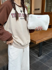White faux shearling large capacity makeup bag with zipper closure and logo patch
