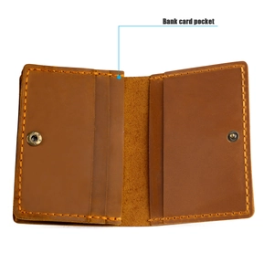 Detail view of brown vintage leather card holder with bank card pockets and stitching
