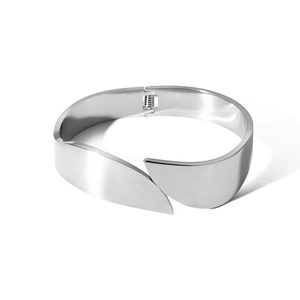 Detail view of the wide silver stainless steel bracelet featuring a hinged closure mechanism