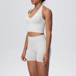 Side view of white seamless ribbed yoga set featuring halter neck top and high waist shorts