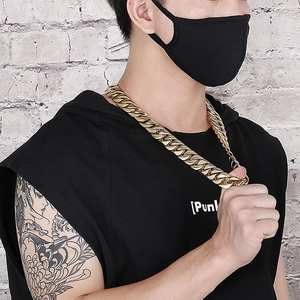 Chunky gold stainless steel Cuban chain necklace for men shown on streetwear model