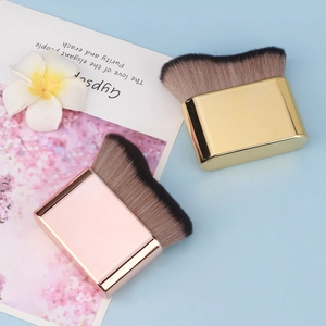 Detail of flat wave foundation brush with metallic handle and soft synthetic bristles