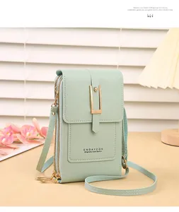 Detail of mint green touch screen phone bag with gold metal buckle and zipper closure