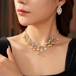 Luxurious silver necklace and drop earrings set with yellow zircon in floral design