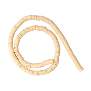Close-up of cream polymer clay heishi beads for DIY jewelry making on white backdrop