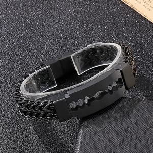 Detail of men's black stainless steel blade bracelet with woven chain and matte finish