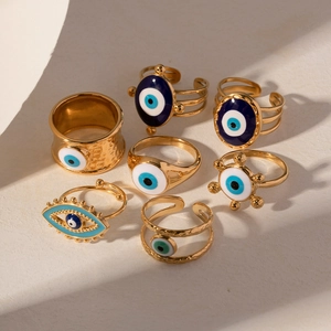 Detailed view of bohemian evil eye ring set in gold finish with blue enamel eye patterns