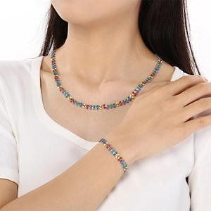 Rainbow colored leaf necklace and bracelet set in polished silver worn by a model