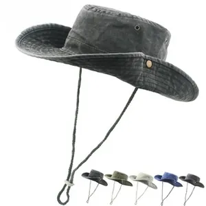 Detail of washed cotton fabric texture and adjustable chin strap on a wide-brim sun hat