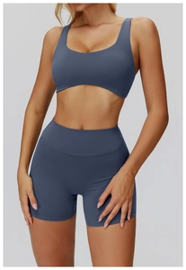 Detail of high-stretch seamless yoga set with thin cross-back straps and high-waist shorts