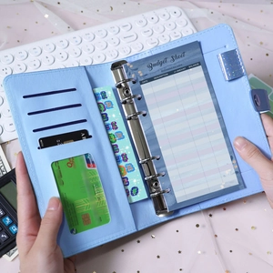 Macro view of A6 light blue PU leather budget binder with 6-ring binder and budget sheets