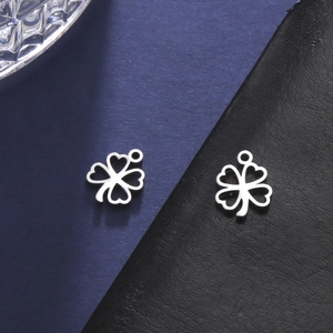 Macro shot of silver four-leaf clover stainless steel pendants for DIY jewelry making