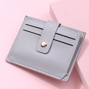 Close-up of litchi texture on slim accordion card holder with golden snap closure
