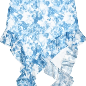 Detail of blue and white tie-dye dress featuring ruffled hem and lightweight fabric