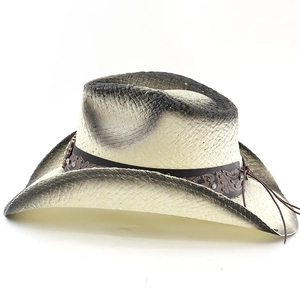 Macro detail of western straw cowboy hat with rhinestone leather band and vintage finish