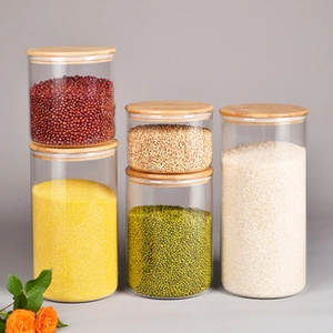 Close-up of glass storage jars with wooden lids in various sizes for kitchen organization