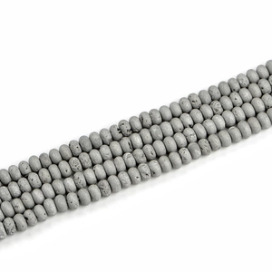 Macro detail of 5x8mm gray geode agate beads with raw texture and abacus shape