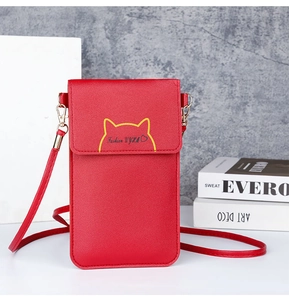 Close-up detail of a red stylish vertical phone crossbody bag with cat ear design