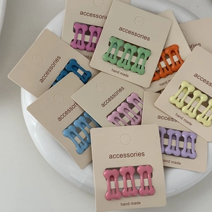 Three-piece set of colorful bone-shaped hair clips with macaron polka dot patterns