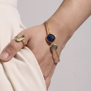 Elegant gold-plated open bangle and ring set featuring faceted blue Czech glass stones