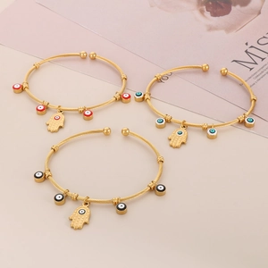 Three gold cable texture bangles with Hamsa hand and colorful Evil Eye charms