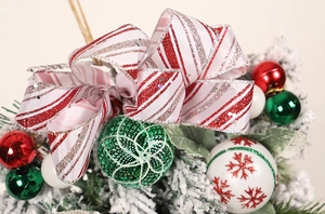 Detailed close-up of Christmas upside-down tree with red-white bows and glitter balls