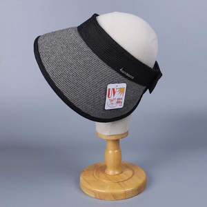 Foldable women's sun hat with wide brim, UV protection fabric, and elegant braided design