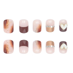 Press-on nails featuring amber marble patterns, gold foil accents, and 3D heart charms
