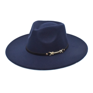 Detail of dark blue wool fedora hat with black leather strap and gold metal buckle