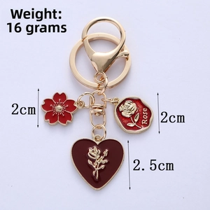 Detail of red enamel charms showing 16g weight and sizes of rose and heart pendants