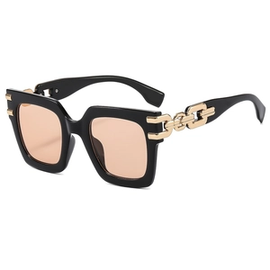 Black square oversized sunglasses with gold chain metal temples and champagne lenses
