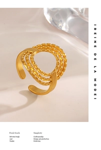 Detailed view of gold plated hollow round ring with beaded texture and adjustable band