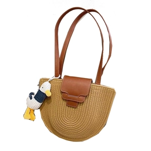Brown leather and straw woven half-moon shoulder bag with a cute cartoon duck charm