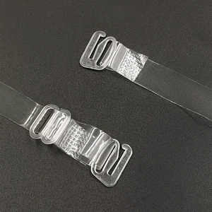 Transparent invisible TPU bra straps with adjustable plastic hooks on a grey background
