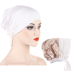 Detailed view of dual-layer white jersey cap featuring smooth champagne satin lining