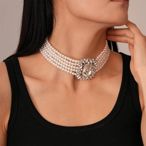 Detail of multi-layer pearl choker with a crystal centerpiece on a model's neck