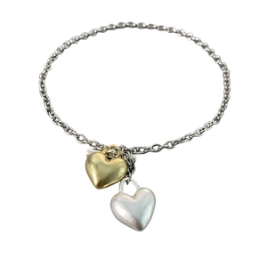 Retro heart-shaped pendant necklace with gold and silver dual tones on a sleek chain