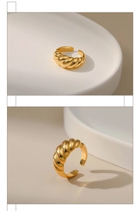 Macro detail of gold plated croissant dome ring with polished ribbed texture