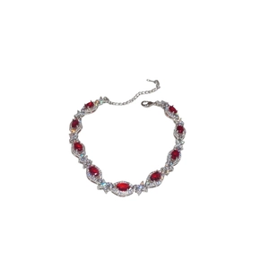 Elegant silver bracelet featuring oval red zircon stones and sparkling crystals