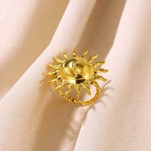 Adjustable golden bohemian sun and moon ring with textured rope band on beige linen