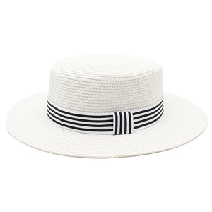 Detail of white woven flat-top straw hat with classic black and white striped ribbon