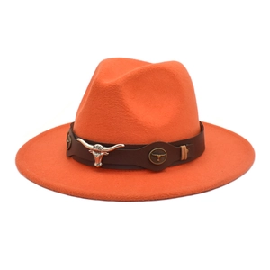 Detail of orange wool fedora featuring a leather band with silver bull head ornament