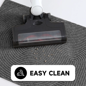 Vacuum cleaning a grey striped floor mat demonstrating the easy clean feature