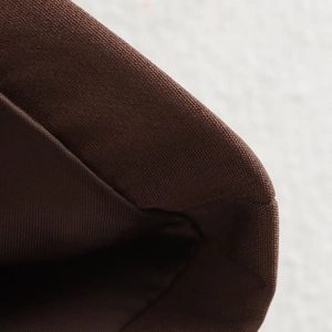 Close-up of retro brown canvas blazer set featuring premium texture and fine stitching detail